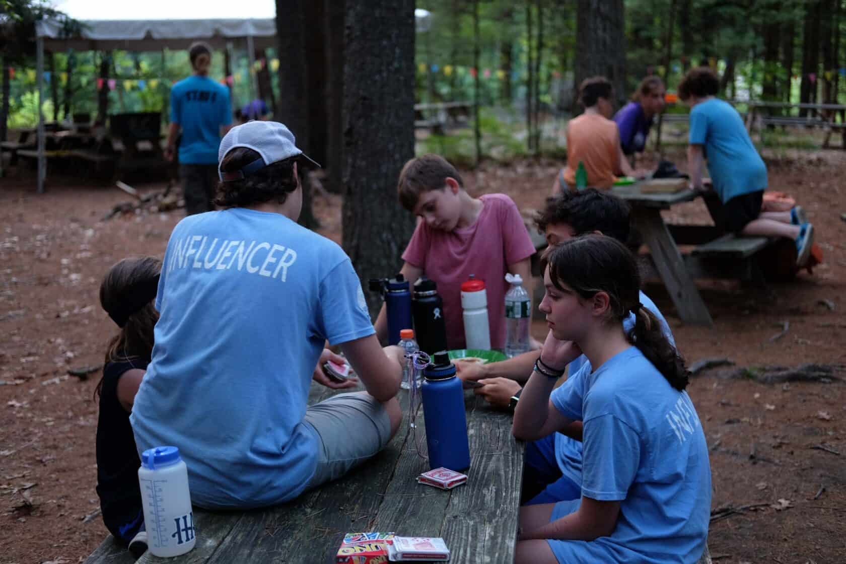 Kids gathered around a wooden table together.