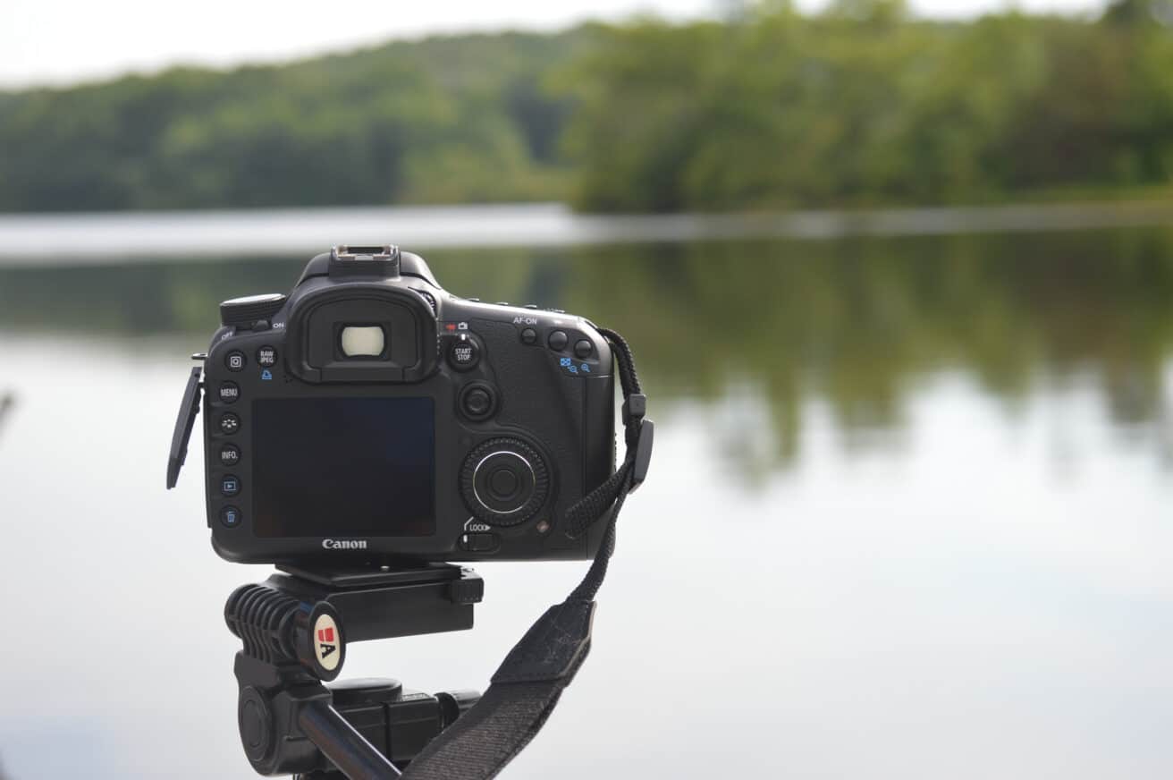 DSLR camera facing a lake.