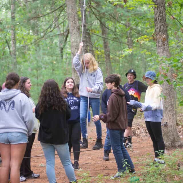 Teens on low ropes course.