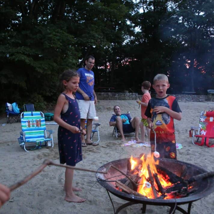 Kids around a campfire.