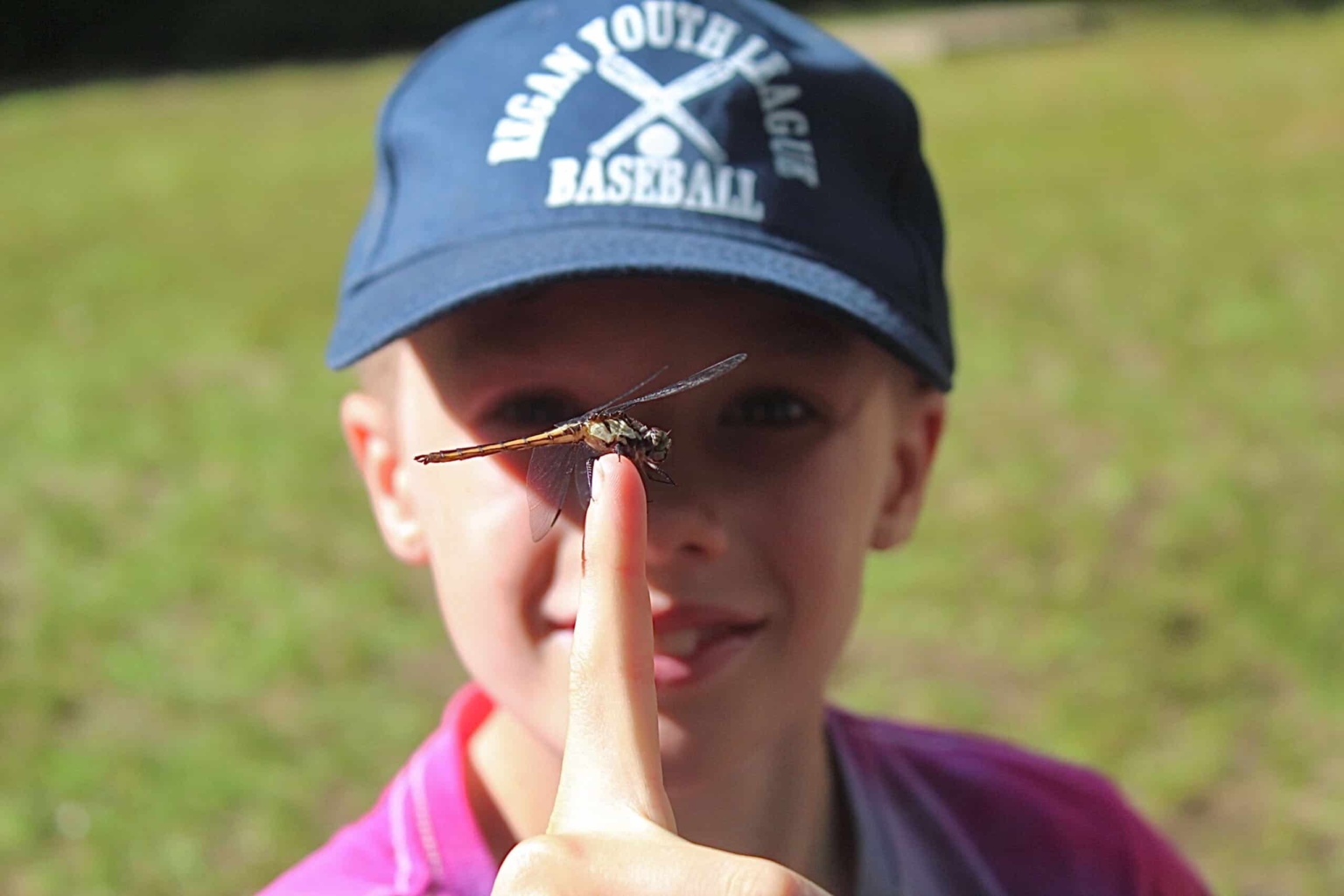 Boy with a dragonfly on his finger.