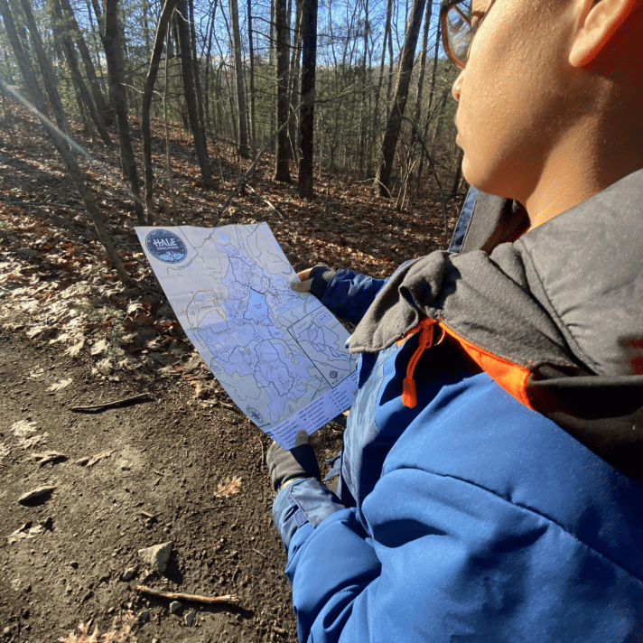 Student reads map to navigate trails
