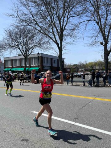 Boston Marathon runner cheering.