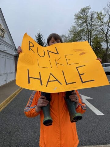 Boston Marathon fan holds up a sign to support runners
