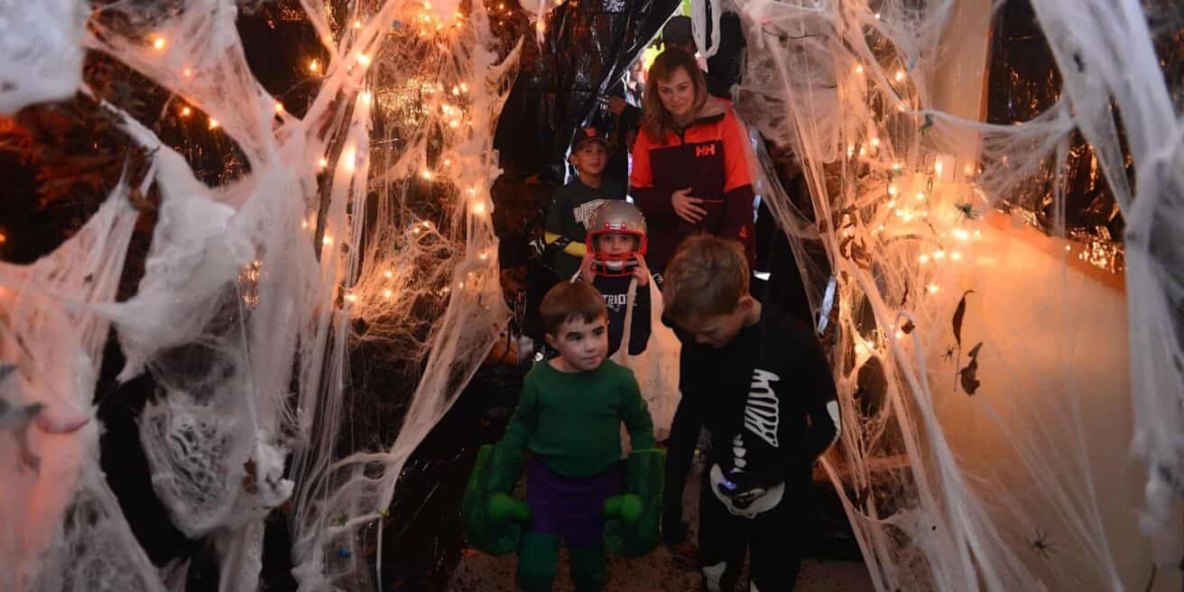 Kids walking through a Halloween spooky house.