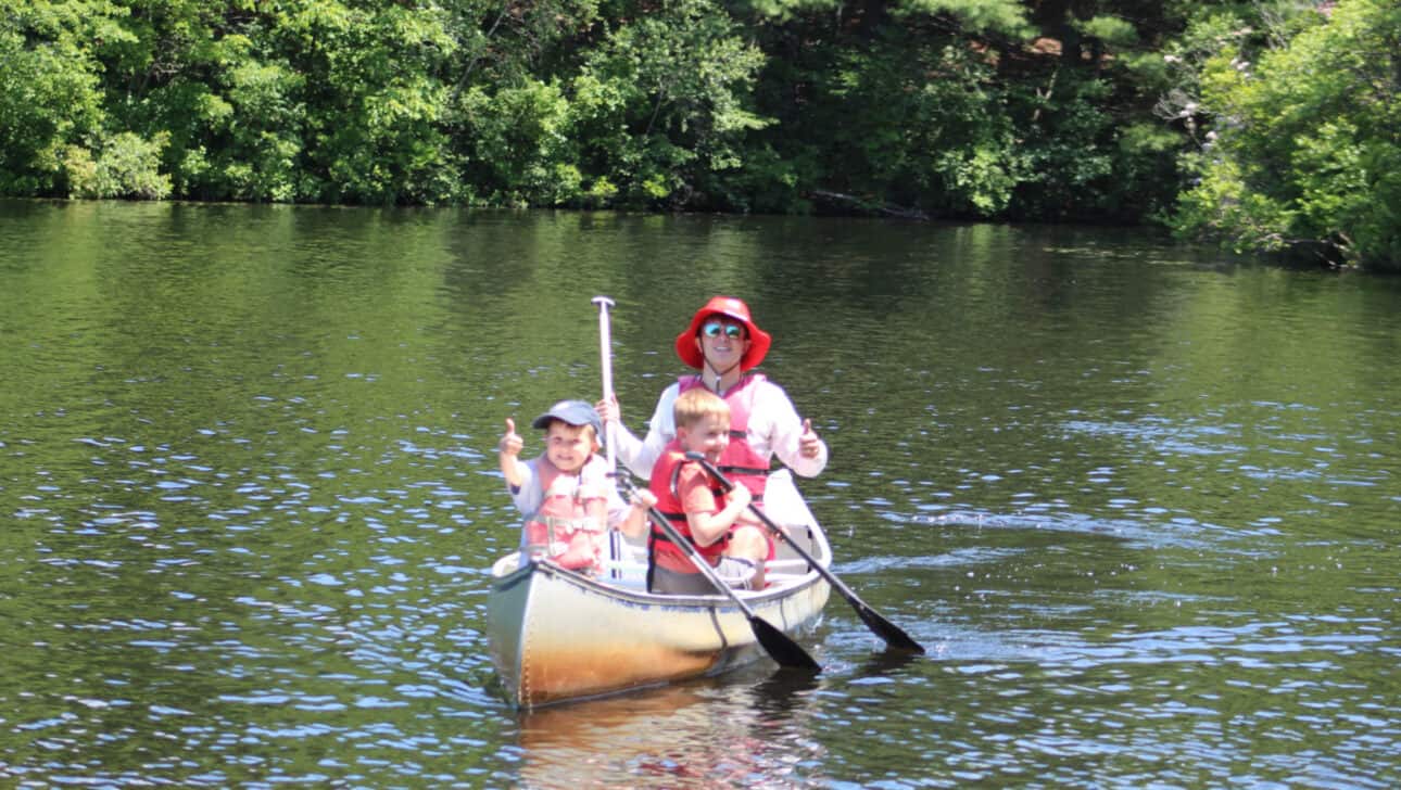 Counselor in Training canoeing with campers.