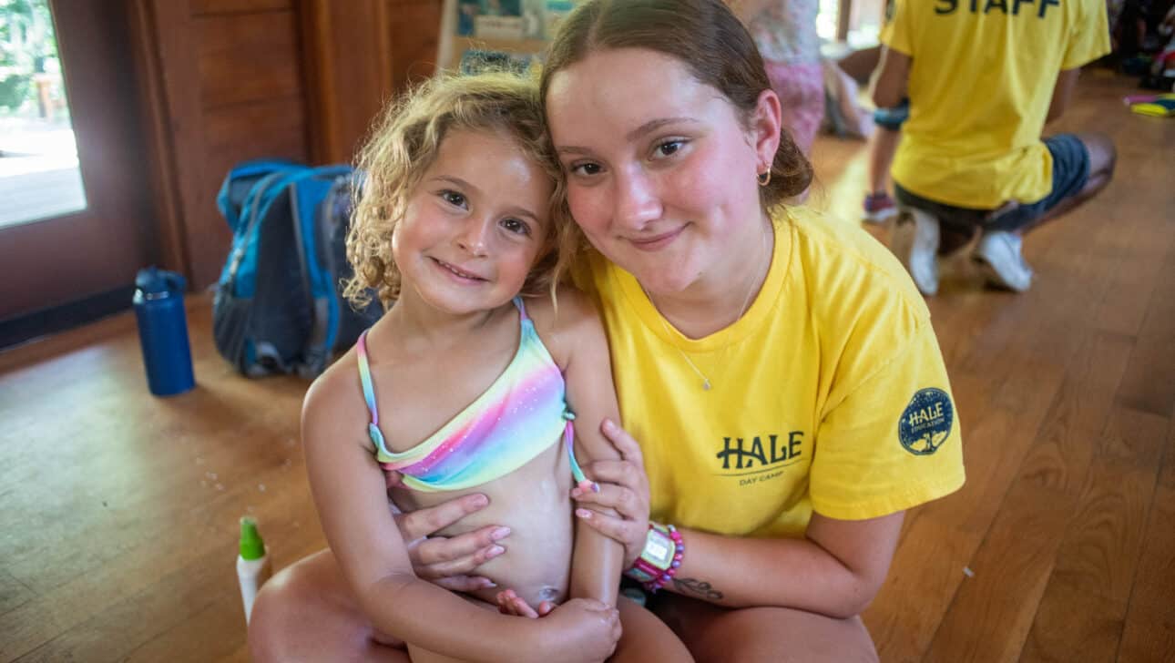 Counselor in Training smiling with a young camper.