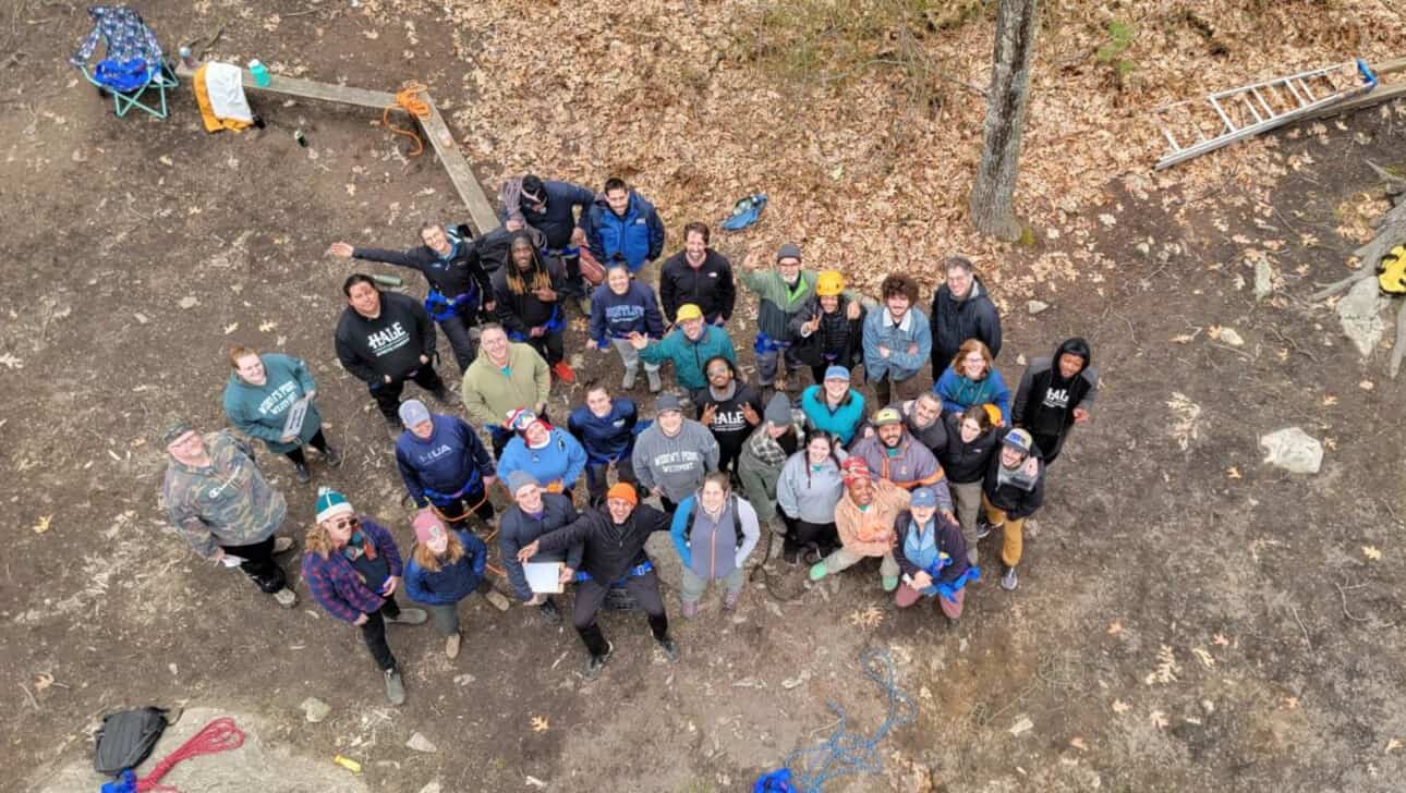 Group photo of participants standing on the ground.