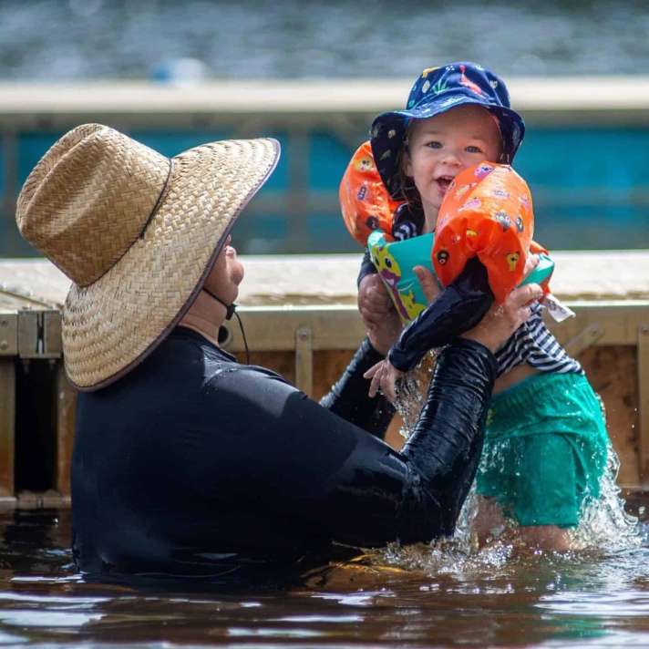 Father with child in the lake.