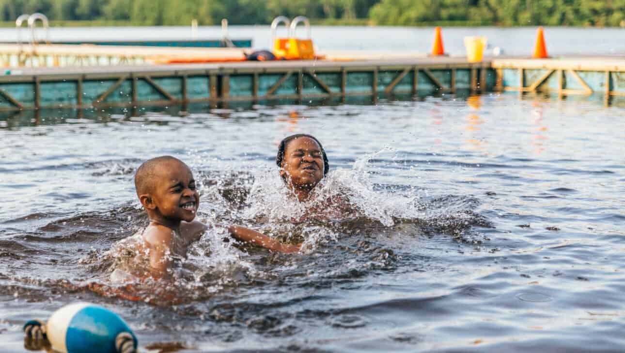 Kids playing in the water together.