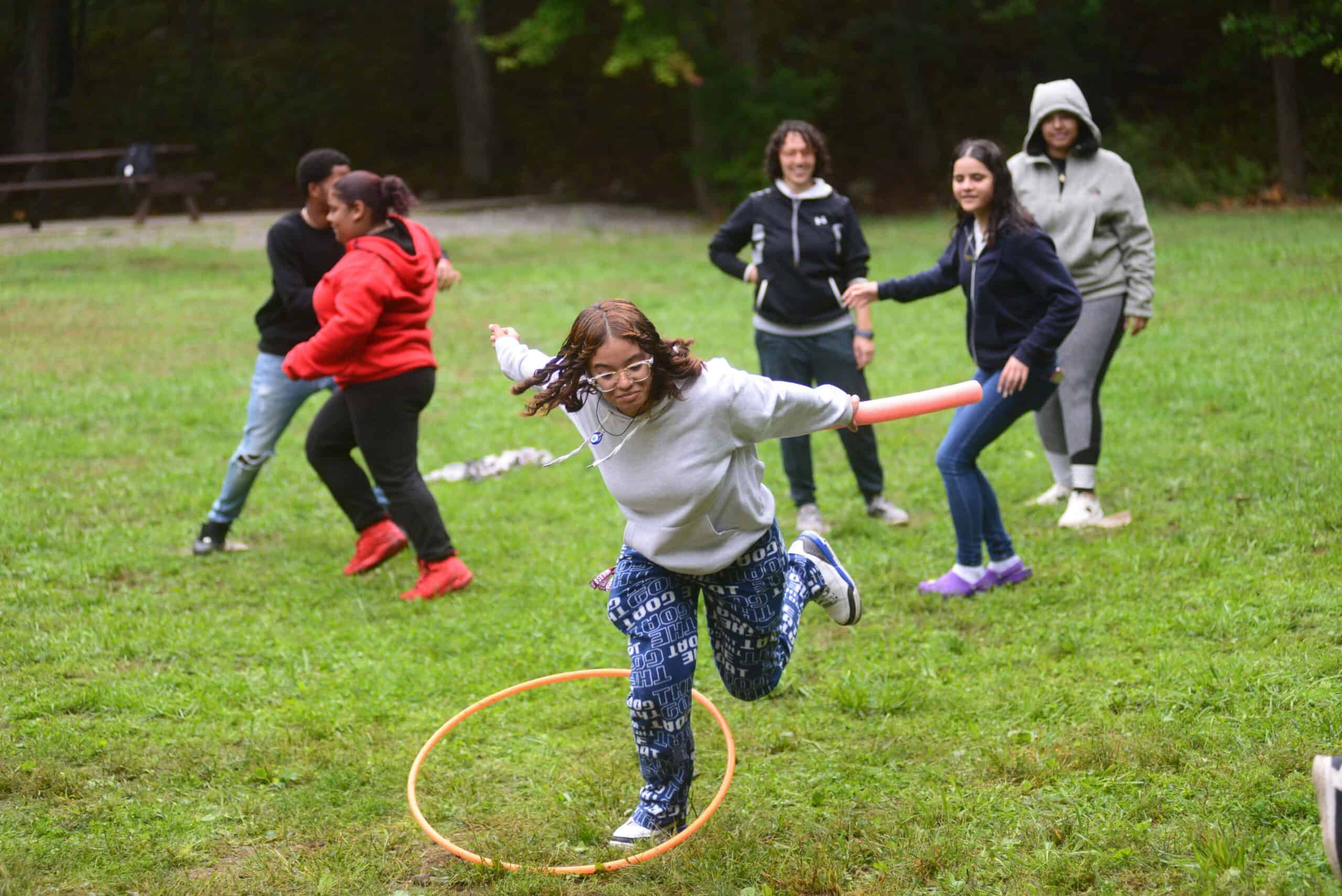 High school students from Boston complete an activity in a field.