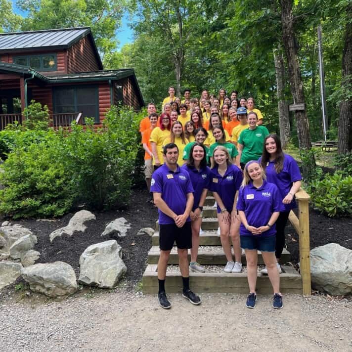 A summer camp staff poses for a photo