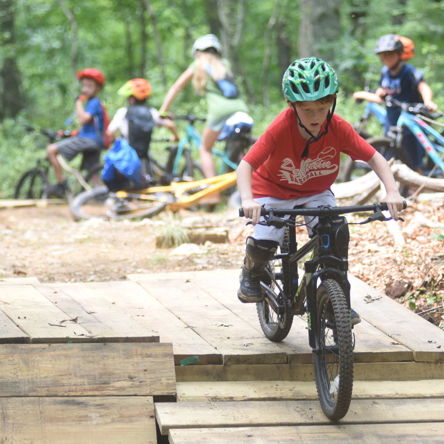 An elementary school student learns to mountain bike.