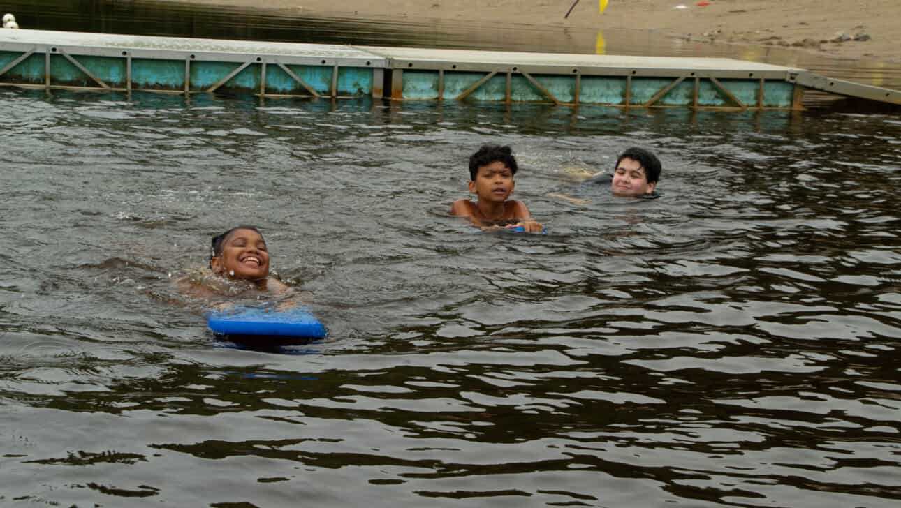 A group of people swimming in a body of water.