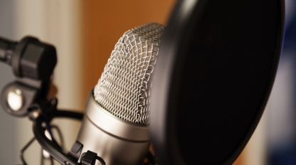 A studio microphone with black filter in close-up