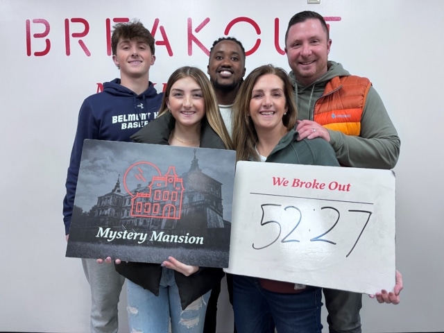 A family celebrates after breaking out of an escape room